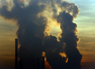 The sun sets behind a power plant powered by coal in the Bosnian town of Tuzla, 120 km north of Sarajevo, Bosnia, Saturday, Dec. 12, 2015. (AP Photo/Amel Emric)