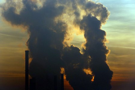 The sun sets behind a power plant powered by coal in the Bosnian town of Tuzla, 120 km north of Sarajevo, Bosnia, Saturday, Dec. 12, 2015. (AP Photo/Amel Emric)