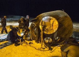 A search and rescue team works on the site of landing of the Soyuz TMA-17M capsule with the International Space Station crew near the town of Dzhezkazgan, Kazakhstan, Friday, Dec. 11, 2015. A three-person crew, U.S. space agency’s Kjell Lindgren, Russia’s Oleg Kononenko and Kimiya Yui of Japan, from the International Space Station landed safely Friday in the snowy steppes of Kazakhstan. (Andrey Shelepin/Pool Photo via AP)