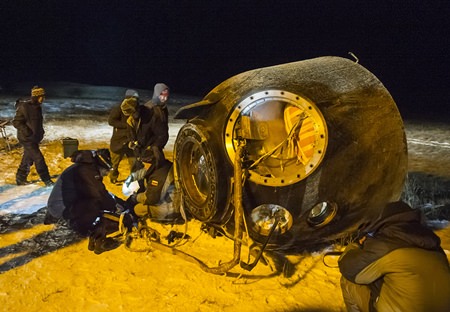 A search and rescue team works on the site of landing of the Soyuz TMA-17M capsule with the International Space Station crew near the town of Dzhezkazgan, Kazakhstan, Friday, Dec. 11, 2015. A three-person crew, U.S. space agency’s Kjell Lindgren, Russia’s Oleg Kononenko and Kimiya Yui of Japan, from the International Space Station landed safely Friday in the snowy steppes of Kazakhstan. (Andrey Shelepin/Pool Photo via AP)