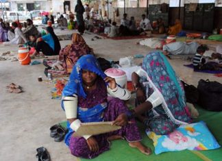 In this June 25, 2015 file photo, people sit outside a local hospital where hundreds of people are admitted suffering from heatstroke and dehydration due to sever weather in Hyderabad, Pakistan. Earth’s wild weather this year is bursting the annual heat record, the World Meteorological Organization announced Wednesday, Nov. 25. (AP Photo/Pevaiz Masih, File)