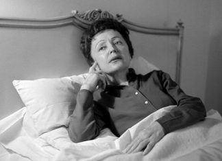 French songstress Edith Piaf props up in bed at the Waldorf-Astoria Hotel in New York in this Feb. 20, 1959 file photo. (AP Photo/Matty Zimmerman)