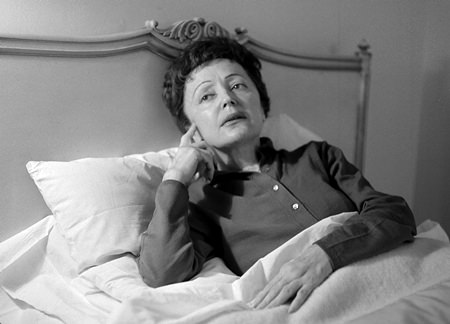 French songstress Edith Piaf props up in bed at the Waldorf-Astoria Hotel in New York in this Feb. 20, 1959 file photo. (AP Photo/Matty Zimmerman)