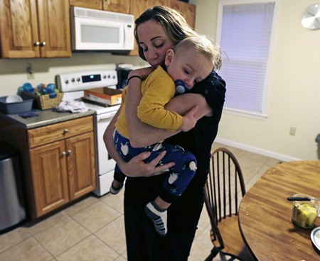 Cancer survivor Christine Ells embraces her twenty-month-old son Jameson after arriving home from work in Whitman, Mass. Ells, 36, a teacher in the Boston suburb of Quincy, developed a heart rhythm problem from several drugs she was given to treat the breast cancer she was diagnosed with at age 27. Certain cancer drugs, such as Herceptin and doxorubicin, sold as Adriamycin and other brands, can hurt the heart’s ability to pump, and lead to heart failure. (AP Photo/Charles Krupa)