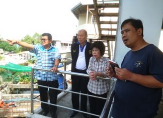 Deputy Mayor Verawat Khakhay (left) escorts Councilman Banlue Kullavanitjaya and other council members to the Naklua Canal to inspect two water pumps there, both found to be in need of replacement parts.