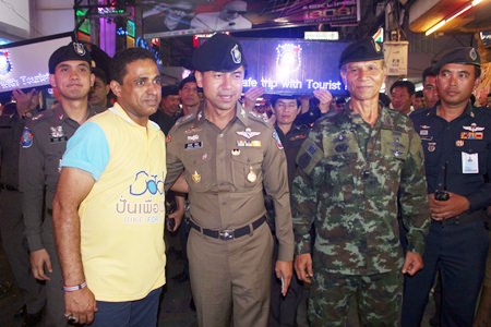 Law enforcement officials toured Walking Street in South Pattaya to assure tourists they were safe, with some officers even holding lighted signs to publicize their point.