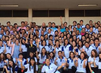 Pattaya municipal employees, politicians, residents and business owners stand with Mayor Itthiphol Kunplome on the front steps at city hall for a group Happy New Year photo.