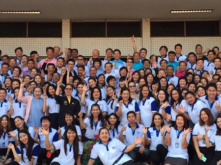Pattaya municipal employees, politicians, residents and business owners stand with Mayor Itthiphol Kunplome on the front steps at city hall for a group Happy New Year photo.