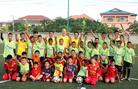 Ossi Schnieder, former coach of the Pattaya United (centre rear), poses with the young soccer students at the Palladium football field off, Soi Korphai, January 21.