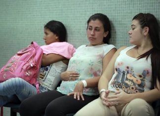 In this Thursday, Feb. 11, 2016 file photo, Daniela Rodriguez, 19, six-weeks pregnant, sits between two other women who are expecting, as they wait for test results after being diagnosed with the Zika virus at the Erasmo Meoz Hospital in Cucuta, Colombia. (AP Photo/Ricardo Mazalan)