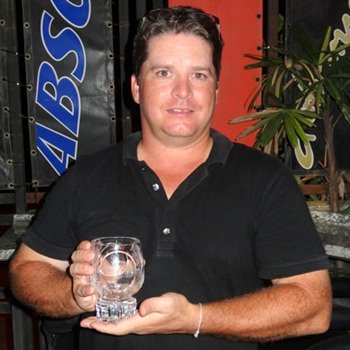 Neil Carter with the golfer of the month cut glass trophy.