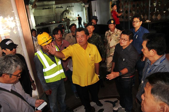 Banglamung District Chief Chakorn Kanjawattana and Pattaya Deputy Mayor Verawat Khakhay point out where the illegal add on to Bali Hai Plaza needs to be demolished to open up the flood canal and help reduce flooding in the rest of the city.