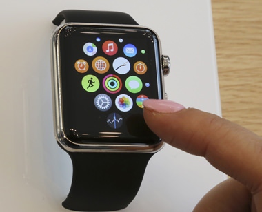 In this April 10, 2015, file photo, a customer demonstrates the Apple Watch at an Apple Store in Tokyo. Upcoming changes to Apple and Android smartwatches should address many of the frustrations the first generation of owners have, though the improvements alone might not be enough to win over those still on the fence. (AP Photo/Koji Sasahara, File)