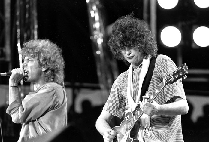 In this July 13, 1985 file photo, singer Robert Plant, left, and guitarist Jimmy Page of the British rock band Led Zeppelin perform at the Live Aid concert at Philadelphia’s J.F.K. Stadium. Generations of aspiring guitarists have tried to copy the riff from Led Zeppelin’s “Stairway to Heaven.” A Los Angeles court now will try to decide whether the members of Led Zeppelin themselves ripped off that riff. Page and Plant are named as defendants in the lawsuit brought by the trustee of late guitarist Randy Wolfe from the band Spirit. (AP Photo/Rusty Kennedy, File)