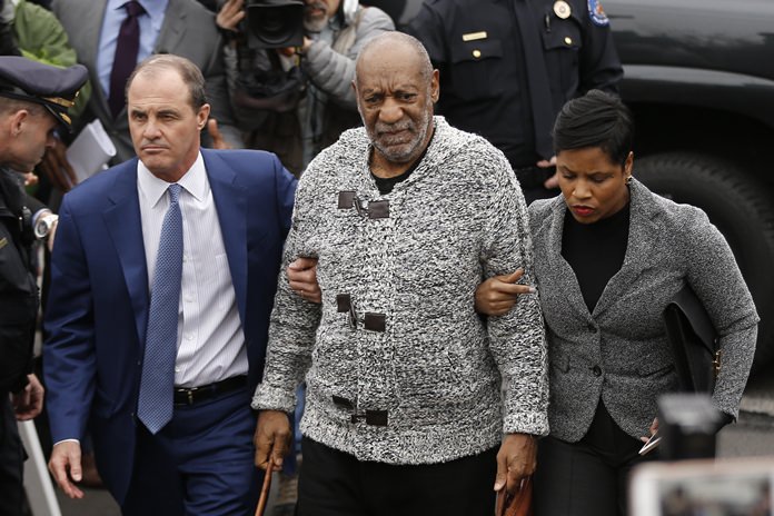 In this Dec. 30, 2015, file photo, Bill Cosby, center, accompanied by his attorneys Brian McMonagle, left, and Monique Pressley, arrives at court in Elkins Park, Pa. to face a felony charge of aggravated indecent assault. (AP Photo/Matt Rourke, File)
