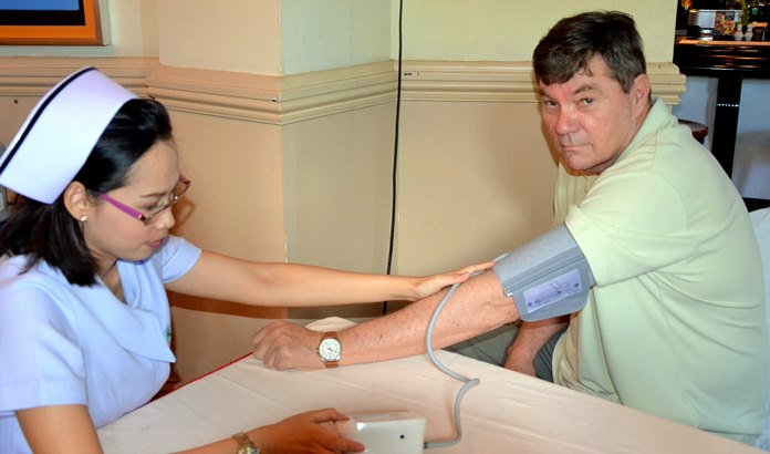 Member Bob Erend takes advantage of a free blood pressure check from a nurse with Phyathai Hospital Sriracha being provided for members and guests at the Sunday, June 19, PCEC meeting.