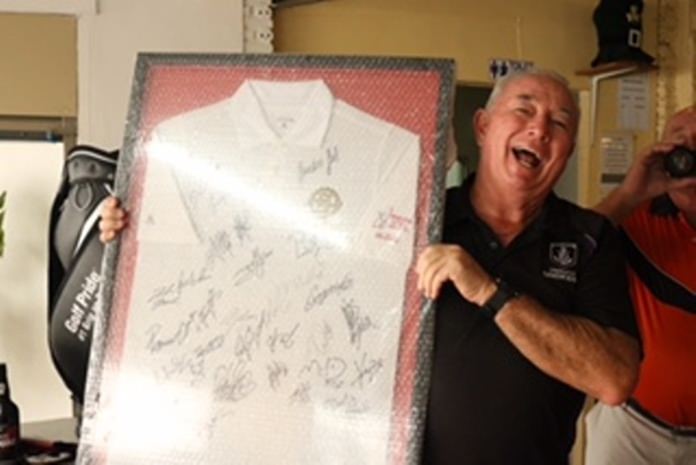 Bob Bower holds up the shirt signed by the ladies at the Honda LPGA at Siam Old course.