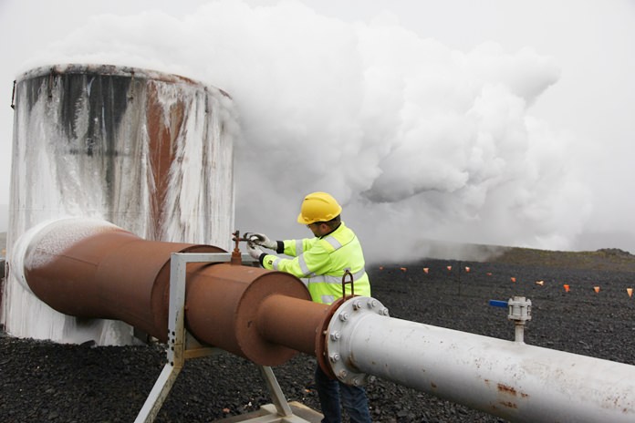 In this July 28, 2011 file photo, a CarbFix experiment’s technical manager checks a valve at a test well at Reykjavik Energy’s Hellisheidi geothermal power plant in Iceland. Scientists have a found a quick but not cheap way to turn heat-trapping carbon dioxide into harmless rock. (AP Photo/Brennan Linsley, File)