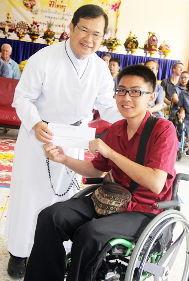 Father Michael presents a student with an award for excellence.