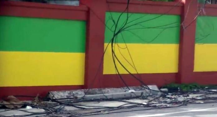 Messy wires near the entrance of Wat Boonsampan School pose a threat and a messy image.