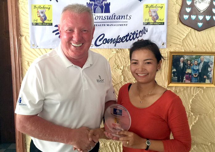 Brian Chapman from Haven Consultants (left) presents a medal trophy to ladies’ winner Saipin Woollett.