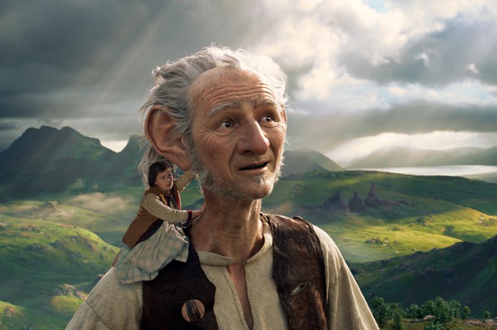 This image released by Disney shows Ruby Barnhill and the Big Friendly Giant from Giant Country, voiced by Mark Rylance, in a scene from”The BFG.” (Disney via AP)