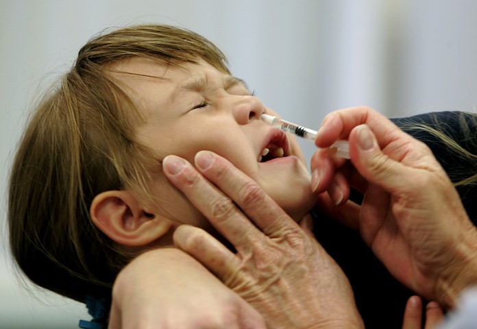 In this Oct. 4, 2005 file photo, a Danielle Holland reacts as she is given a FluMist influenza vaccination in St. Leonard, Md. On Wednesday, June 22, 2016, federal officials reported the latest in a growing series of study findings that show AstraZeneca’s nasally-administered FluMist has not been working. (AP Photo/Chris Gardner, File)