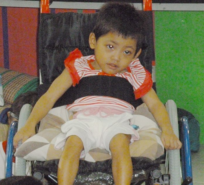 Fahsai when she received her new wheelchair at 4 years ago at the Hand to Hand Foundation.