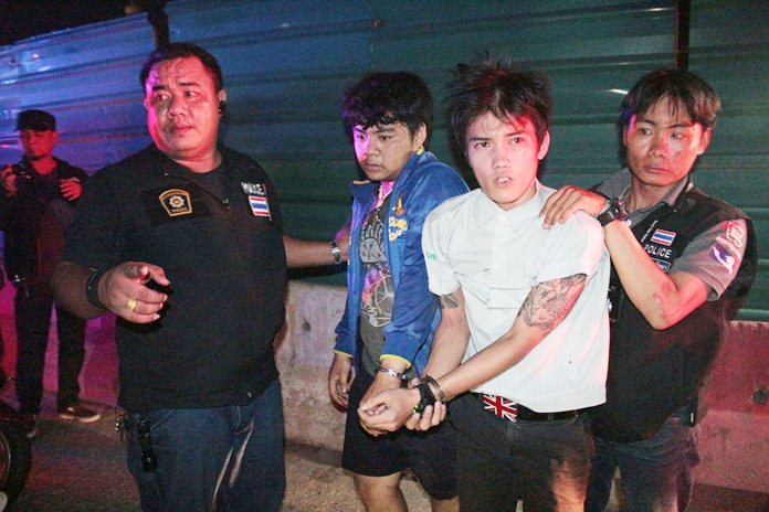 Permsap Boothsara and Chakrit Ampaisa are taken into custody after they ran a police checkpoint.