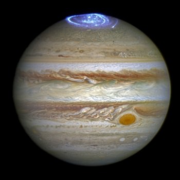 This composite image provided by NASA on Thursday, June 30, 2016 illustrates auroras on the planet Jupiter. This view was produced by NASA using a photograph made by the Hubble Space Telescope in spring 2014, and ultraviolet observations of the auroras in 2016. (NASA/ESA/Hubble via AP)