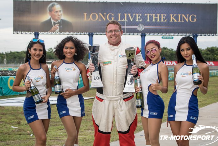 Danish driver Thomas Raldorf (center) of team TR-Motorsport poses with his two second place trophies at the Chang International Circuit in Buriram, July 10.