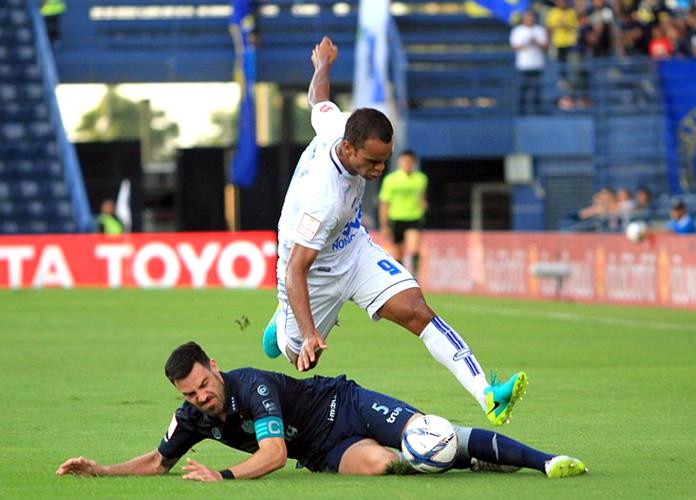 Pattaya United’s ‘Pinto’ Junior Negrao (9) hurdles over a challenge from Buriram United’s Andrés Tunez (5) during their Thai Premier League match at the Thunder Castle Stadium in Buriram, Sunday, July 17. (Photo courtesy Pattaya United)