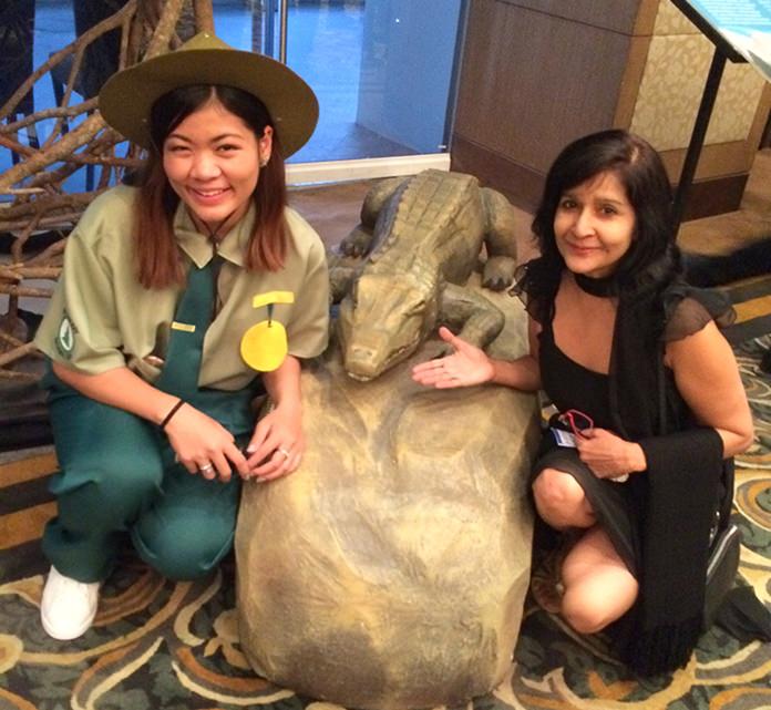 Sue with a national park personnel and a baby gator.