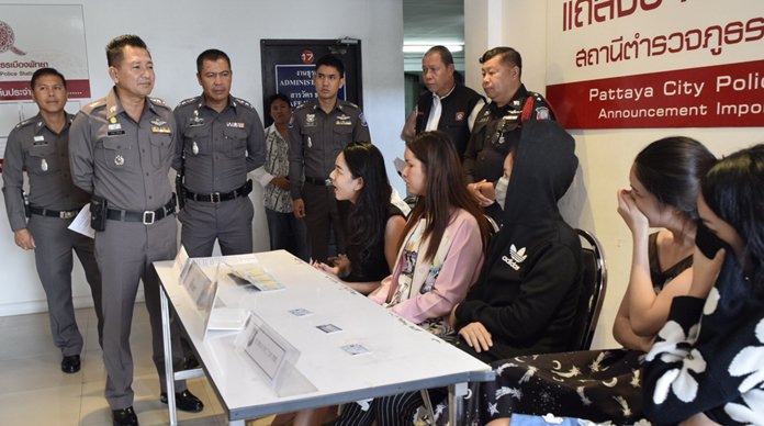 Teo Poh (hiding, background) reported to police he was robbed by six women and transvestites (seated).