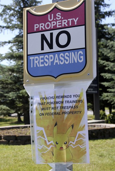 In this Tuesday, July 12, 2016, file photo, a sign at the National Weather Service in Anchorage, Alaska, informs “Pokemon Go” players that it’s illegal to trespass on federal property. The staff started noticing an uptick of people in the parking lot after the location was included as a gym in the popular game. (AP Photo/Mark Thiessen, File)