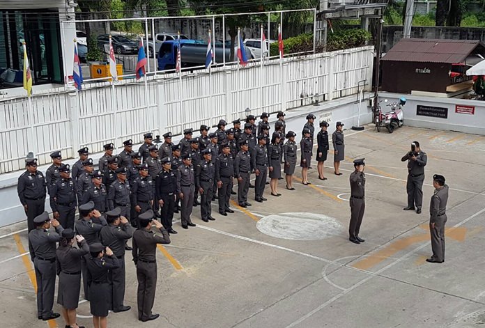 Pol. Col. Sitichai Lokanpai, deputy commander of the eastern region’s Immigration Bureau, inspects the troops at the Chonburi office before receiving an update on pending cases.