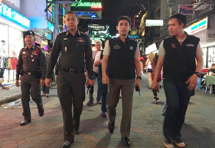 Local Tourist Police Division chief Pol. Maj. Piyapong Ensarn and Pattaya Police chief investigator Maj. Somboon Euasamarnmaithree bring a team of officers through Walking Street to ensure no thieves were preying on tourists.