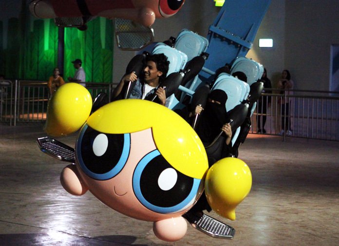 People shout as they experience the Powerpuff Girls - Mojo Jojo’s Robot Rampage ride at the IMG Worlds of Adventure amusement park in Dubai, United Arab Emirates, Wednesday, Aug. 31. (AP Photo/Jon Gambrell)