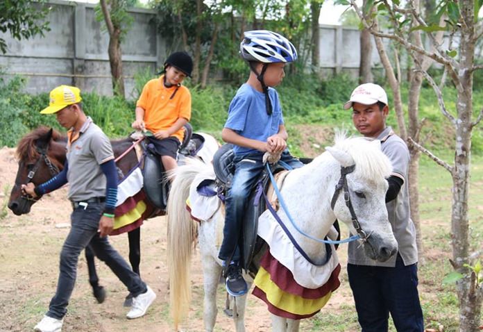 Special-needs children received a physical and emotional boost by riding horses courtesy of Nongprue Sub-district and the Paidi Institute.