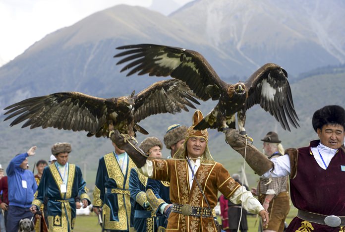 Participants hold golden eagles for an eagle hunt during the second World Nomad Games at Issyk Kul lake in Cholpon-Ata, Kyrgyzstan, Sept. 4, 2016. (AP Photo/Vladimir Voronin)