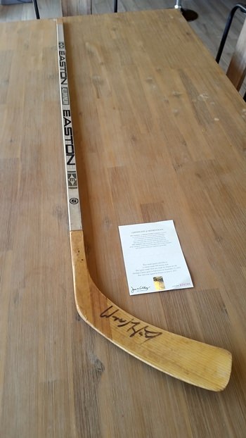 Auction item: Wayne Gretzky signed hockey stick with authenticity document.
