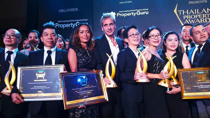 Sukanya and Winston Gale (centre) celebrate with other category winners on stage at the conclusion of the 2016 Thailand Property Awards.