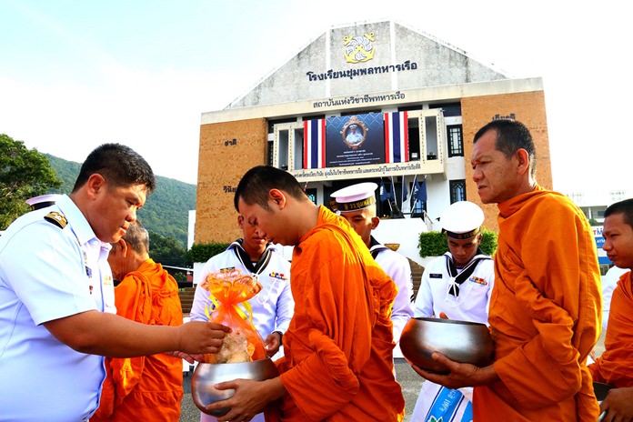 Naval Rating School commander Capt. Wirat Somjit leads the “talk baht’ alms giving Oct. 14.