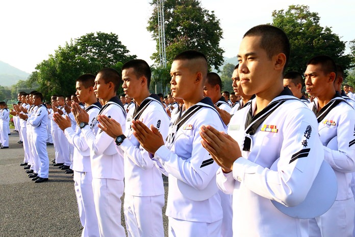 About 1,000 students, enlisted personnel and their families express their condolences on the passing of the monarch, praying for his spirit in the afterworld.