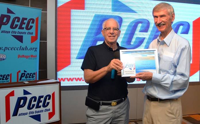 MC Richard Silverberg presents the PCEC’s Certificate of Appreciation to member Ian Frame for his presentation of photographs showing that Pattaya’s streets and beaches can reveal some truly amazing sights.