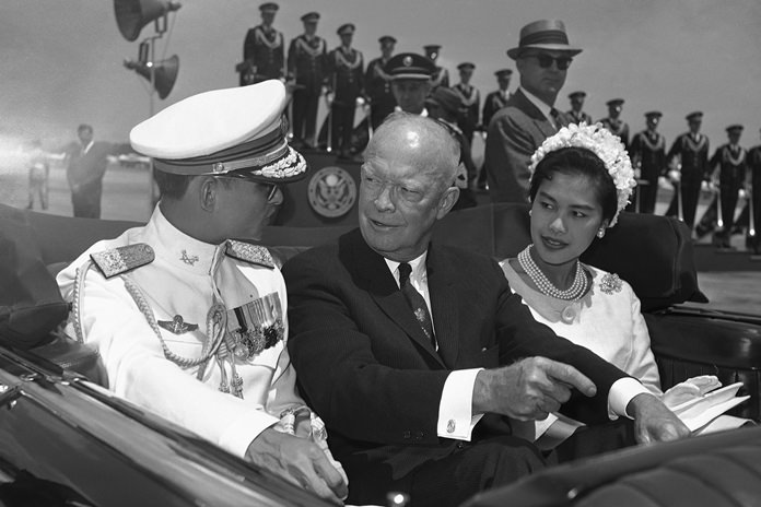 In this June 28, 1960, file photo, U.S. President Dwight Eisenhower, center, is seated between His Majesty King Bhumibol Adulyadej, left, and Her Majesty Queen Sirikit for a motorcade drive from National Airport to the White House in Washington. (AP Photo, File)