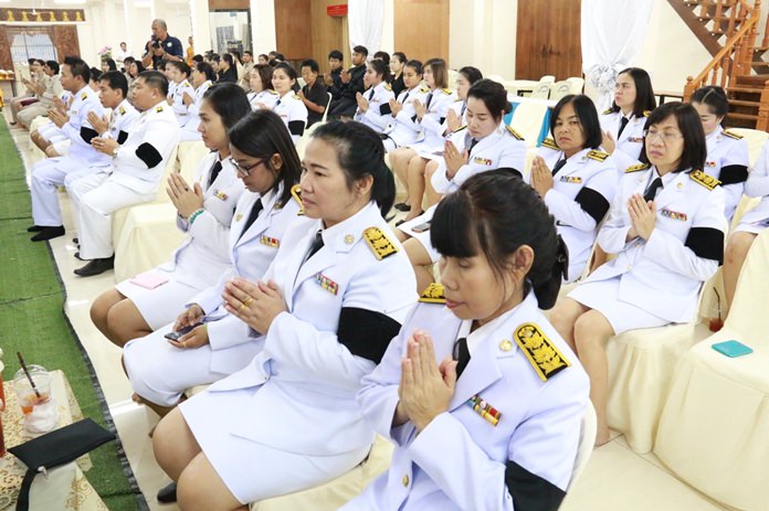 Civil servants pray during the ceremony at the Nongprue municipal office.