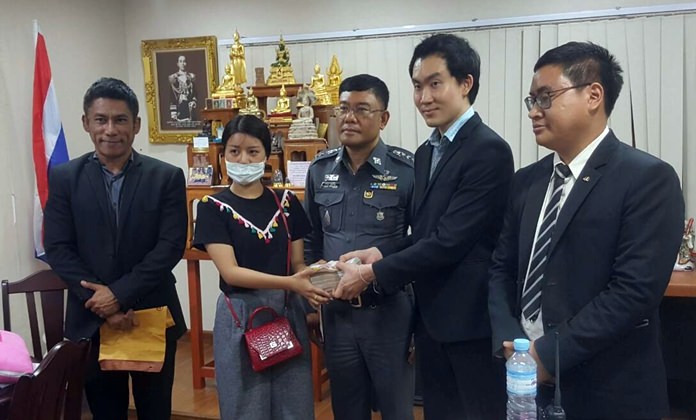 Piyapat Howilailak, owner of V-Safe Clinic on Central Road, presents 765,000 baht to 22-year-old Widara Park to compensate her for cosmetic lip surgery complications.
