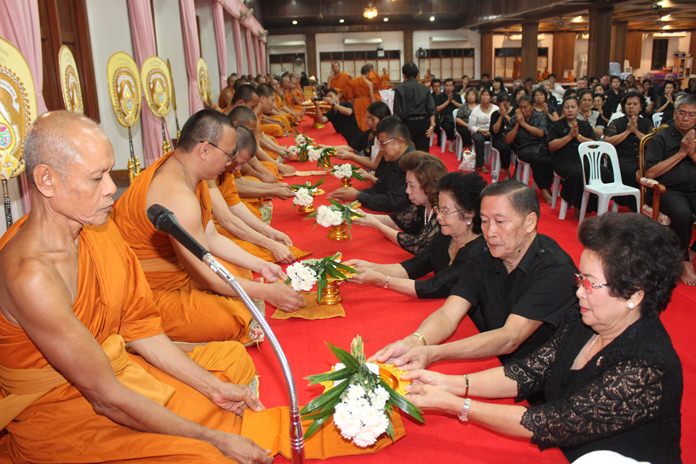 The Khakhay and Ouamsa families make their offerings to the monks during the religious ceremonies.