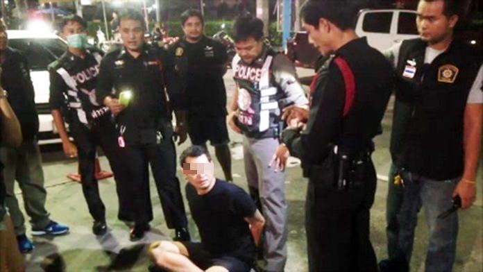 Thechapat Holabuth (seated) and driver Surasak Damrong (not shown) have been charged with drunk driving, disorderly conduct and assaulting a police officer during a highly charged stop at a Pattaya checkpoint.